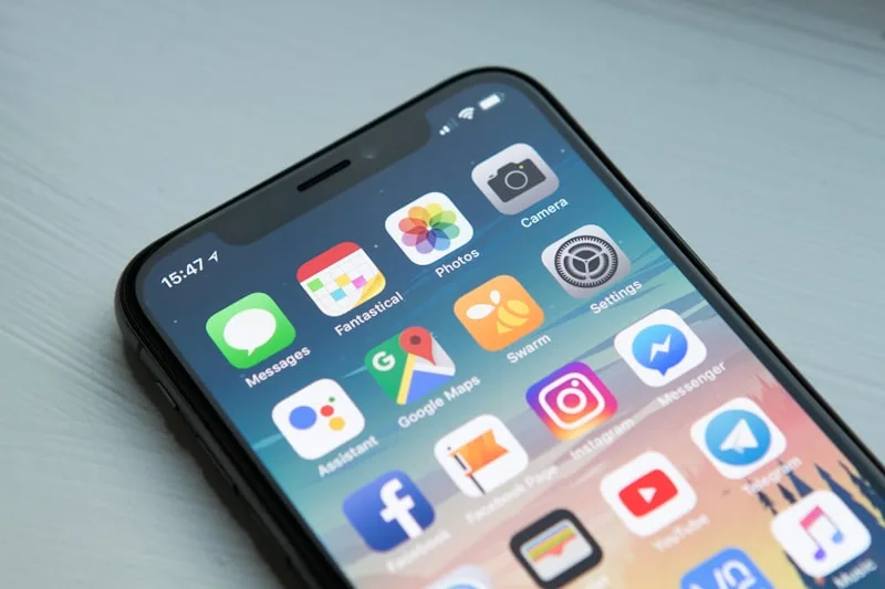 Artisan optimisant sa fiche Google Business Profile sur smartphone — 12 actions concrètes 2026