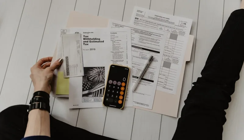 Small business owner checking unpaid invoices on laptop — WhatsApp and email follow-up templates 2026