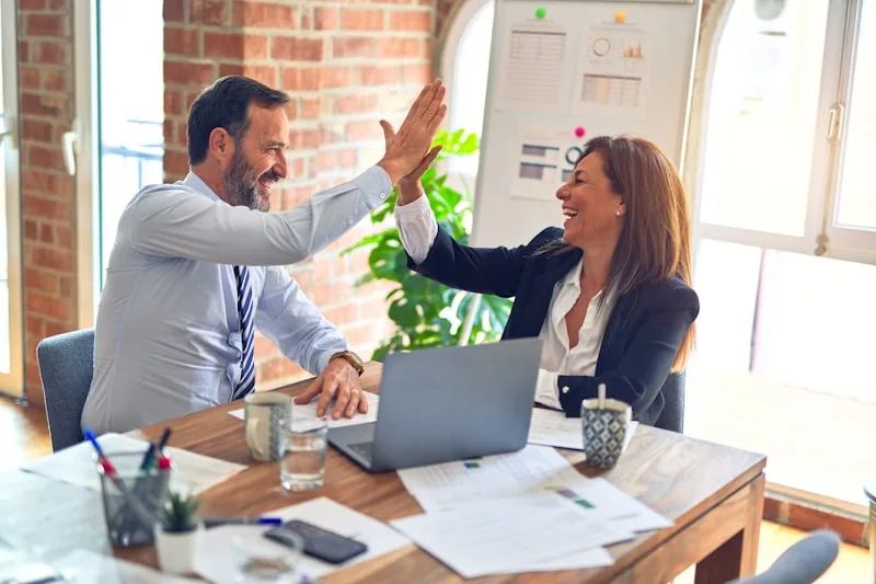 Tradesperson writing a client follow-up message on smartphone — WhatsApp and email templates 2026